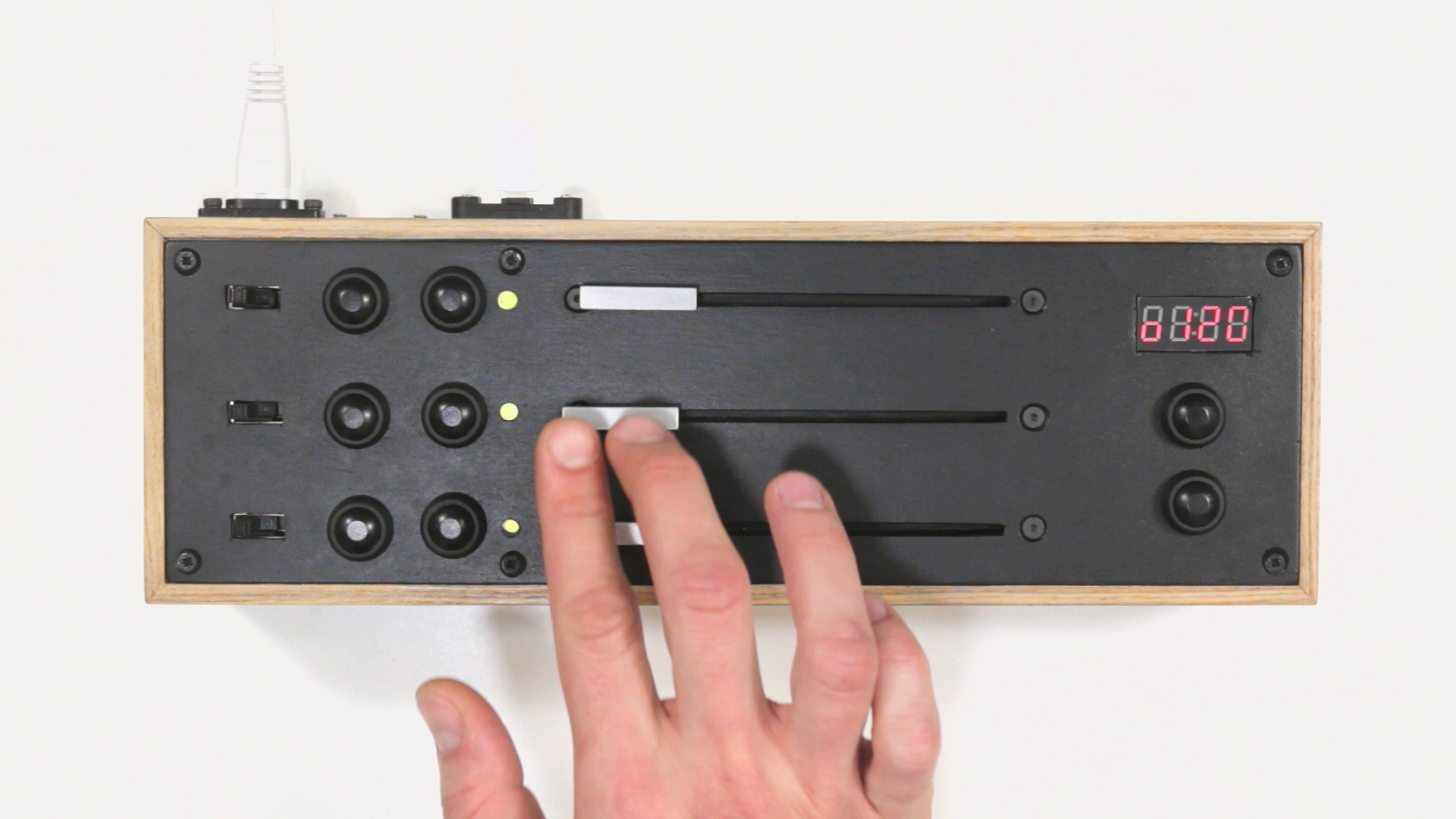 A hand playing the MEMO/MOVE, a midi controller that can control the movements around a sound rather than the sound itself.