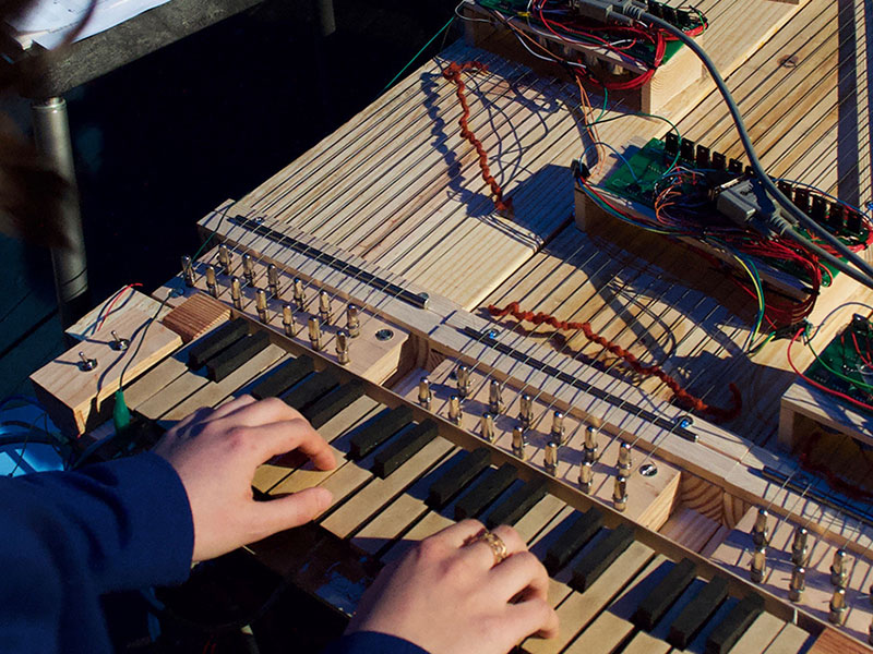 A Guthman competitor plays a keyboard-based instrument she built with Georgia Tech students.