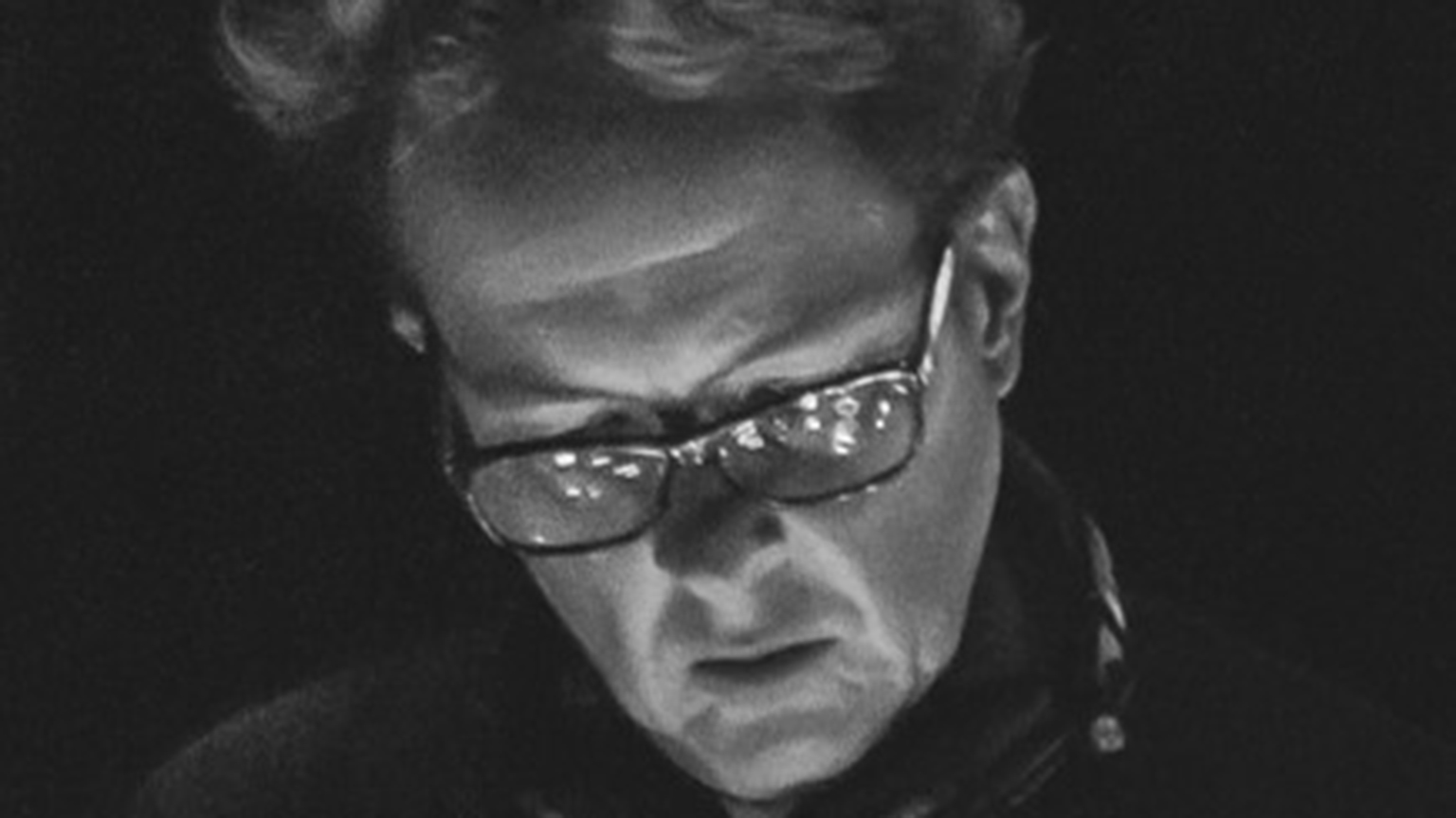 A close up of Peter C. Evans' face in black and white during a performance