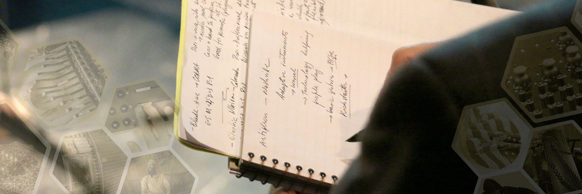 A photo of a Guthman judge's note pad, taken from behind his shoulder as he writes.