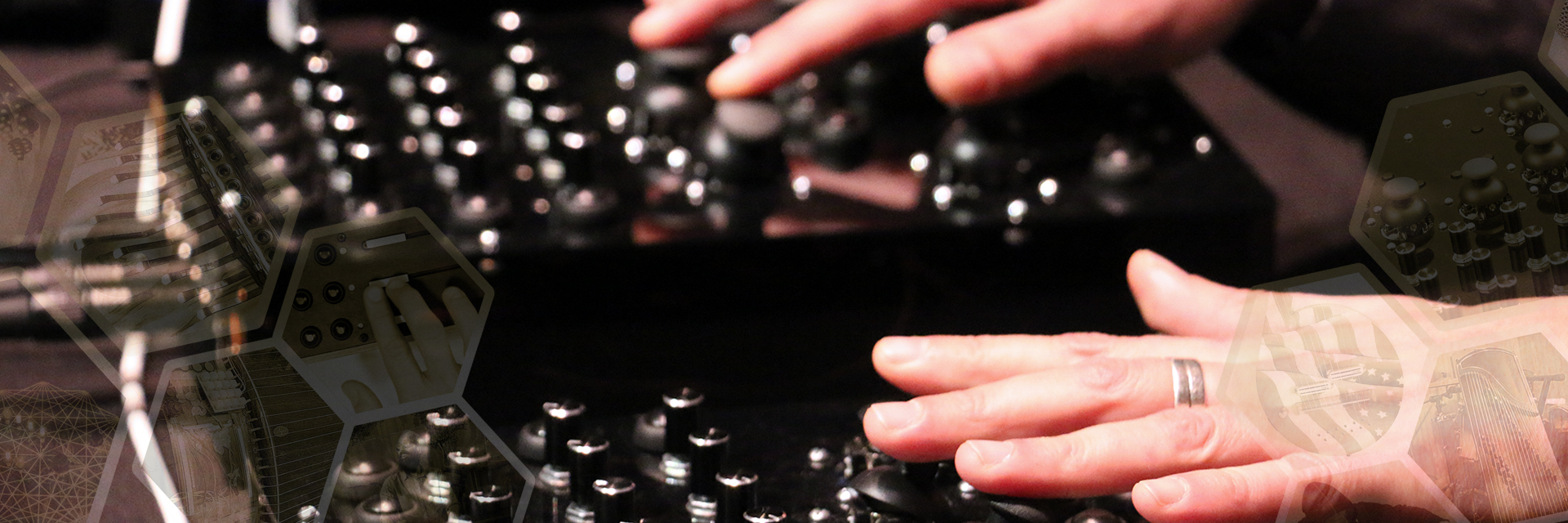 A Guthman Competition contestant's hands manipulate a board full of knobs.